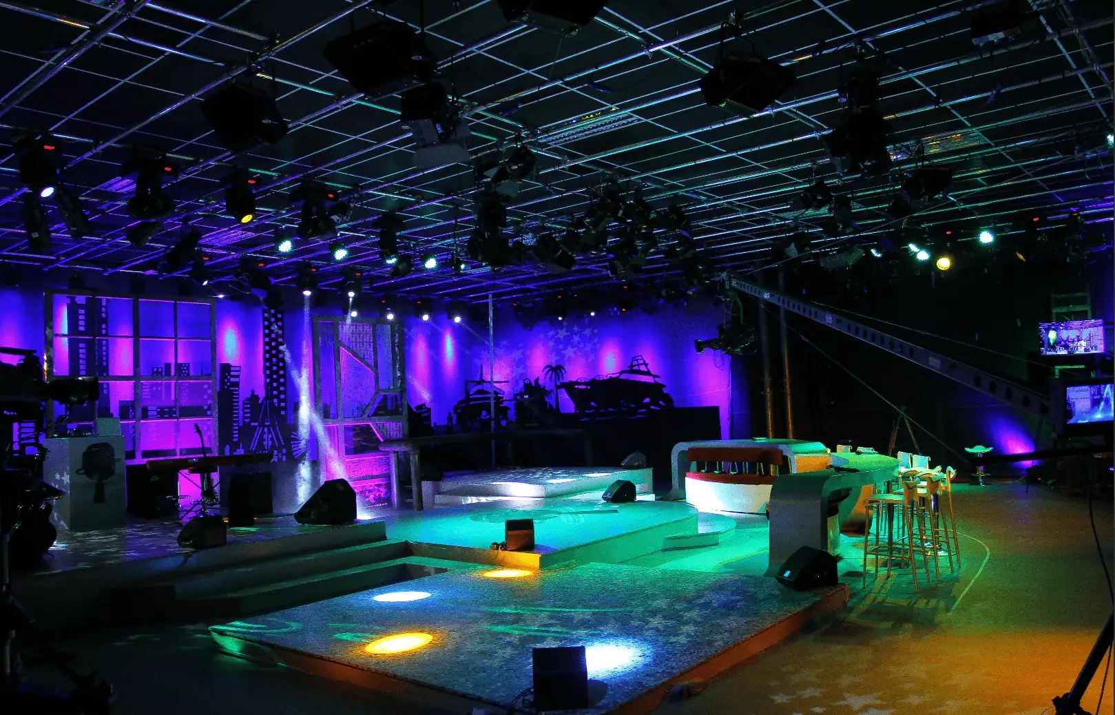 Empty TV studio set with purple and blue stage lights